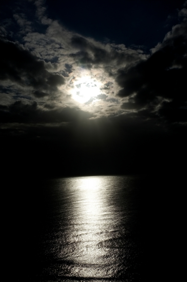 [Image: When the sun sleeps. by @karenabad - The sun peering from behind its blanket of clouds.  on Propic]